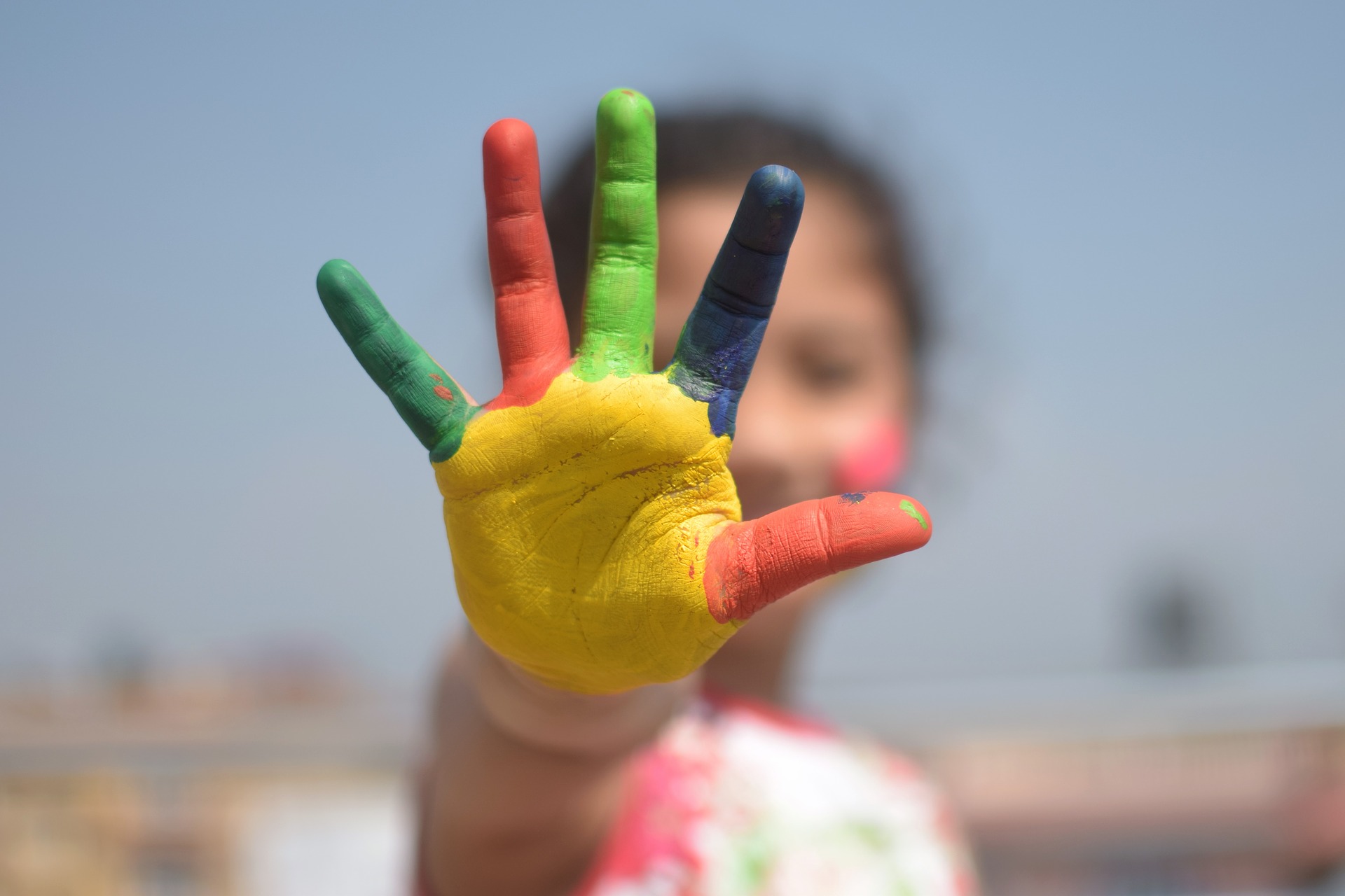 An image of a child's colourful painted hand
