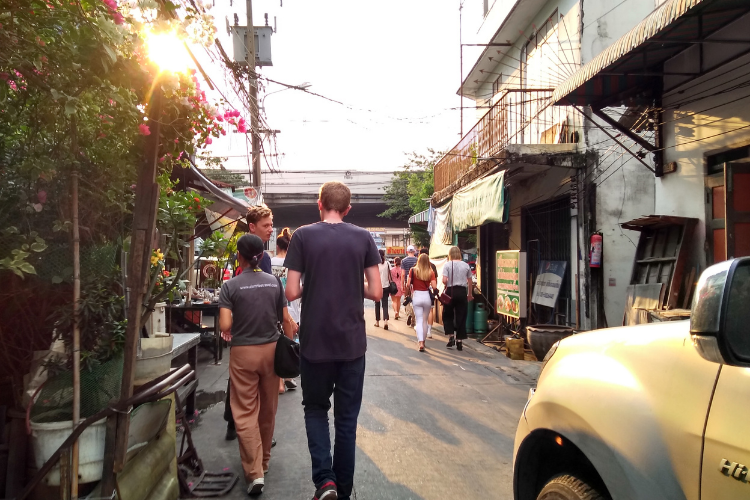 An image of tourists exploring Asian neighbourhood