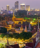 An image of the skyline in Phnom Peh Cambodia featuring the Royal Palace in the foreground looking back towards the business district.